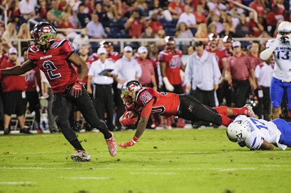 WKU RB, Anthony Wales, tries to dive past a defender