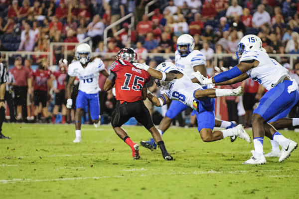 Western Kentucky WR, Nicholas Norris, tries to escape from the clutches of a Memphis defender