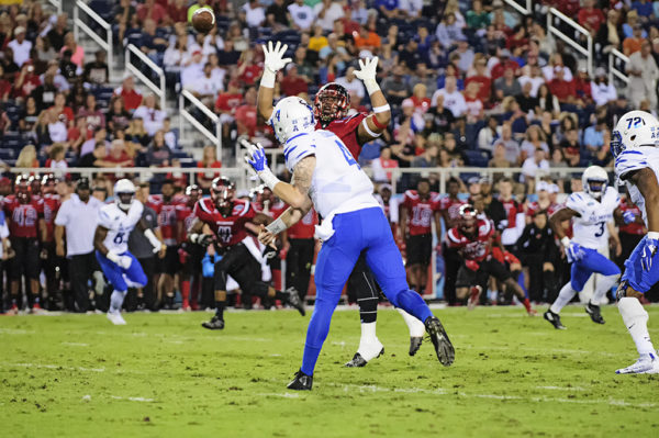 Memphis QB, Riley Ferguson, tries to throw a pass by a defender