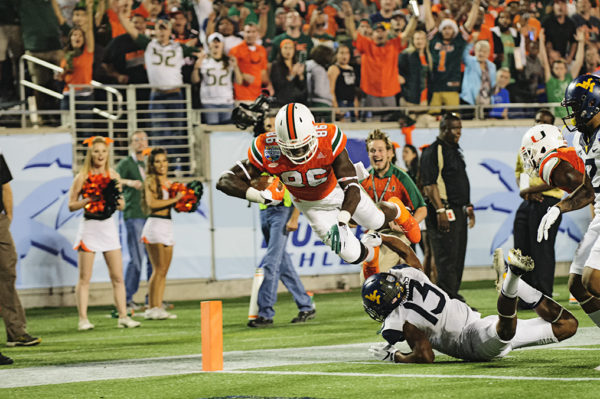 Miami Hurricanes TE, David Njoku, leaps over a defender into the endzone for a touchdown