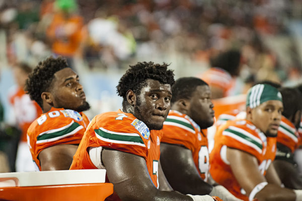 Kendrick Norton, Miami Hurricanes DL, takes a seat on the bench as the Hurricanes offense takes the field