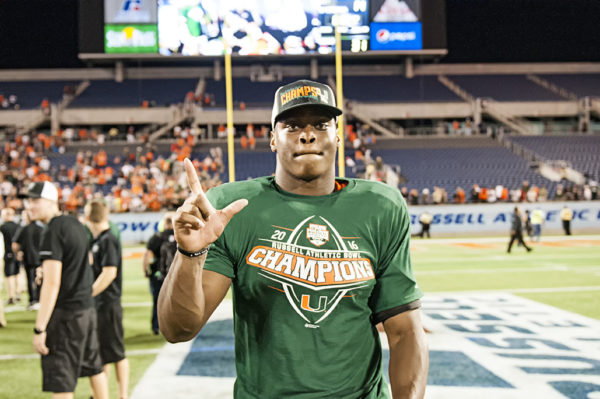 Miami Hurricanes LB, Shaquille Quarterman, goes to celebrate with his teammates