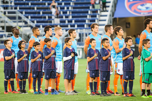 Miami FC players stand for the National Anthem