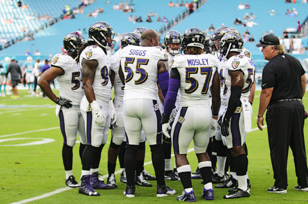 Ravens LBs have a quick huddle during warm ups