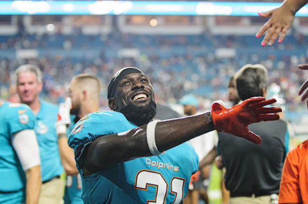 Dolphins S #31, Michael Thomas, gives high fives to fans