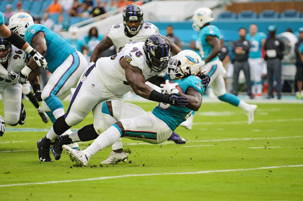 Brandon Williams, Ravens DT #98, stuffs Dolphins RB #23, Jay Ajayi, for a loss