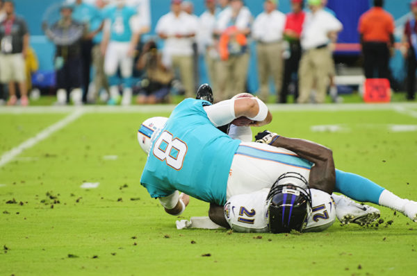 Dolphins QB #8, Matt Moore, gets sacked by #21, Ladarius Webb, of the Ravens