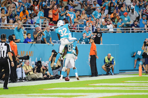 Dolphins RB, #32 Kenyan Drake, jumps on the back of TE, Leonte Carroo, after Carroo scored a touchdown