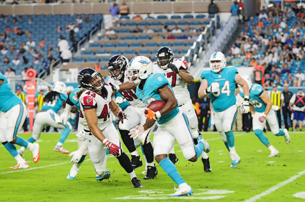 Dolphins RB, #32 Kenyan Drake, turns the corner against the Falcons defense