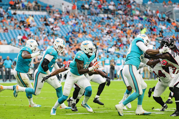 #11, DeVante Parker, runs after completing a catch against the Falcons