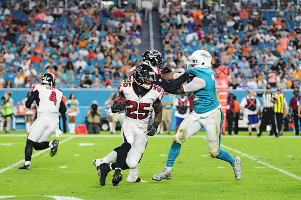 Falcons RB, #25 Brian Hill, looks to cut outside as he rushes the ball