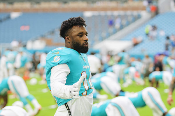 Dolphins WR, #14 Jarvis Landry, greets teammates during stretch