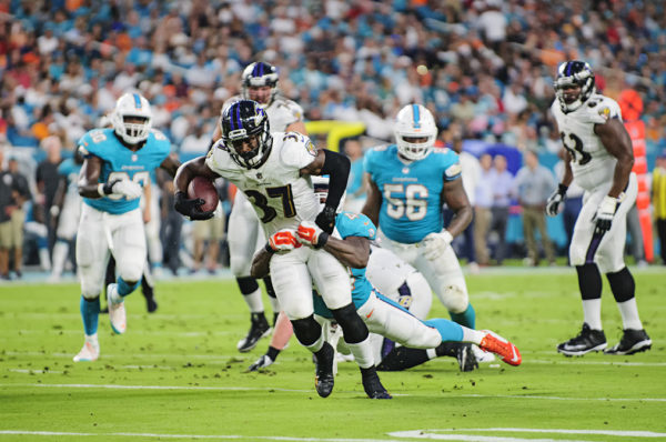 Ravens RB #37, Javorius Allen, tries to break free from a tackle