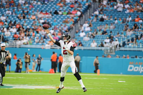 Falcons QB, Matt Ryan, attempts a pass while running out of the pocket