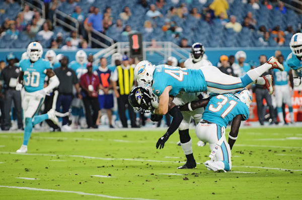 Dolphins LB #45, Mike Hull, jumps on the back of #7, Javorius Allen