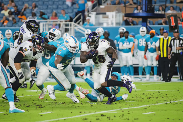 Terrance West, Ravens RB #28, looks to rush for a lane to rush the ball through