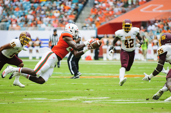 Hurricanes TE, Christopher Herndon, leaps to make a catch