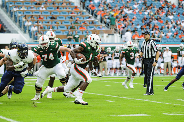 Hurricanes RB, Mark Walton, finds an opening to run through