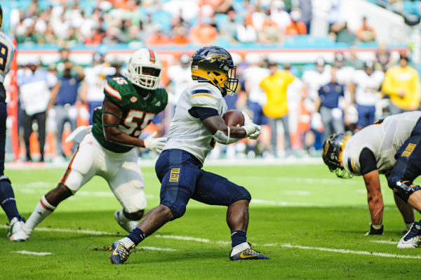 Terry Swanson, Toledo RB, tries to find an opening to run through