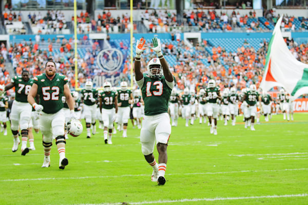 DeeJay Dallas throws up the "U" as the team runs onto the field