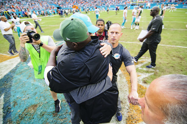 Adam Gase and Todd Bowles hug after the game