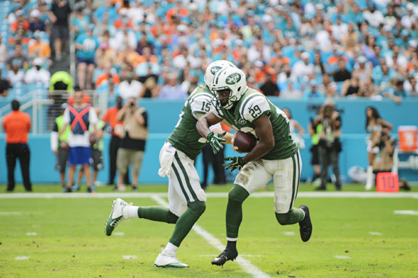 Josh McCown (15) hands the ball off to Bilal Powell (29)
