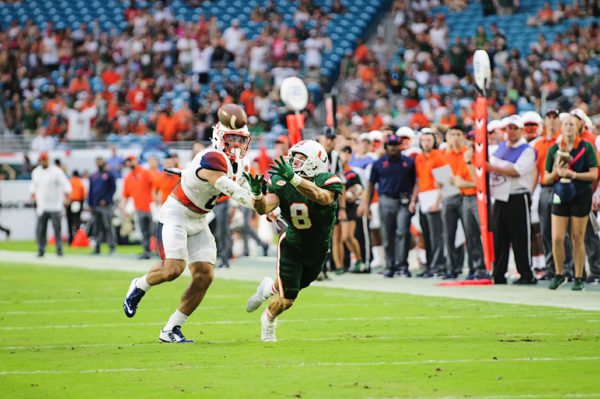 Hurricanes WR, Braxton Berrios, lunges for the ball