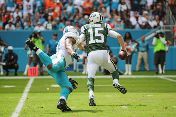 Josh McCown (15) escapes the clutches of Cam Wake (91)