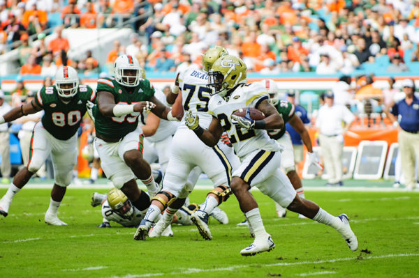 Running back (22) Clinton Lynch runs after a hand-off