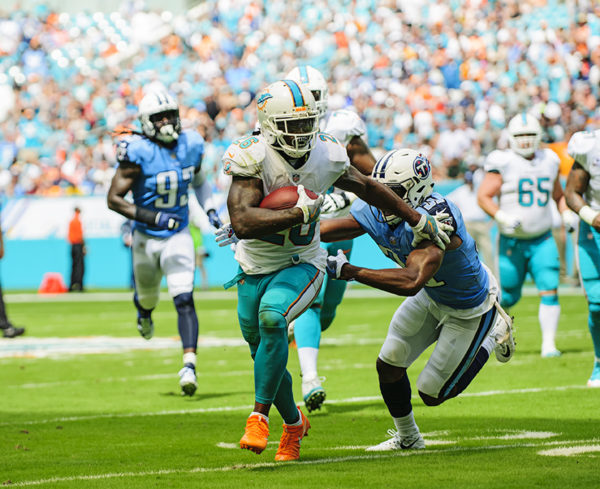 Damien Williams tries to run past a defender