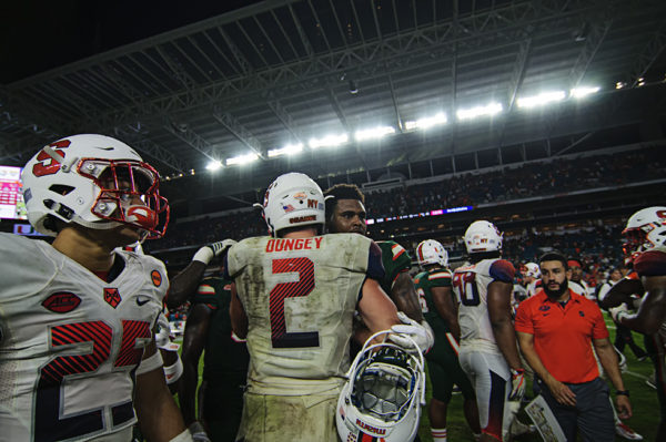 Eric Dungey (2) congrats the Canes after their win