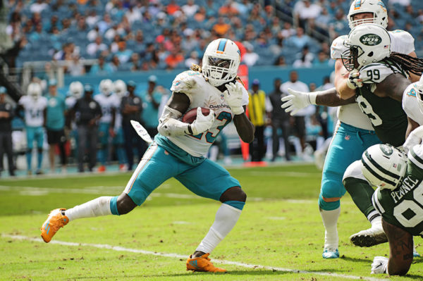 Jay Ajayi begins a spin move to evade the defense