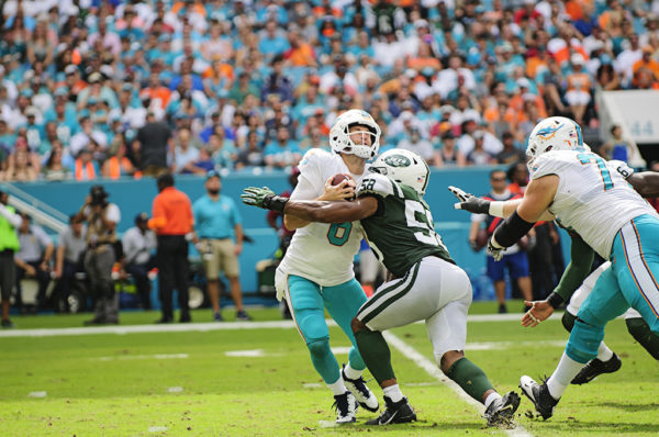 Jay Cutler (6) gets hits by Darron Lee (58)