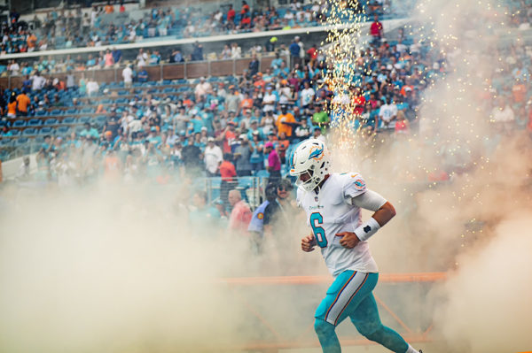 Dolphins quarterback, Jay Cutler, runs through the smoke