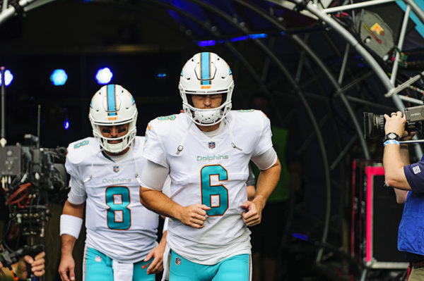 The Dolphins quarterbacks run out for warmups