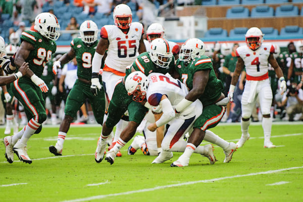 Kendrick Norton (7) and R.J. McIntosh (80) sack Eric Dungey (2)