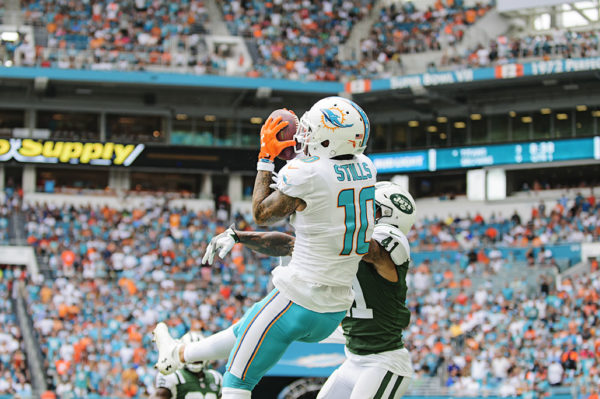 Kenny Stills (10) jumps up to haul a pass in