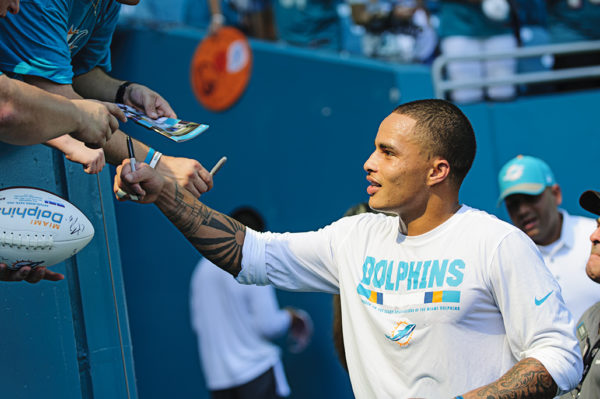 Dolphins WR, Kenny Stills, signs autographs for fans prior to the game