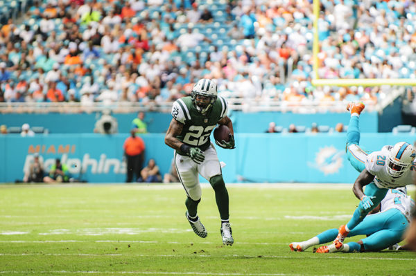 Matt Forte (22) runs past two defenders