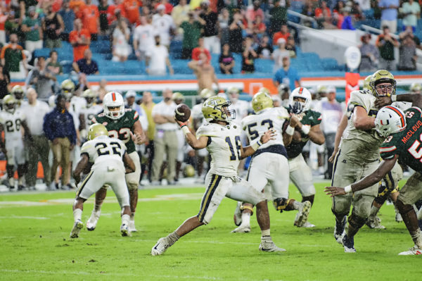 TaQuon Marshall (16) throws a pass in the rain