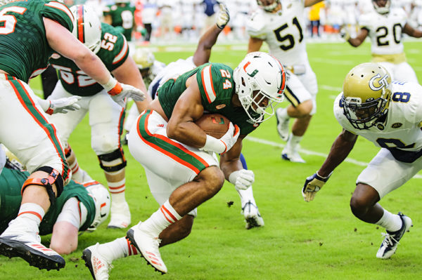 Travis Homer (24) lowers his shoulder in anticipation of contact