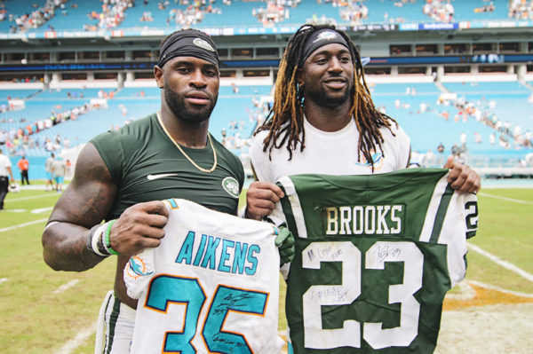 Walt Aikens and Terrence Brooks exchange jerseys