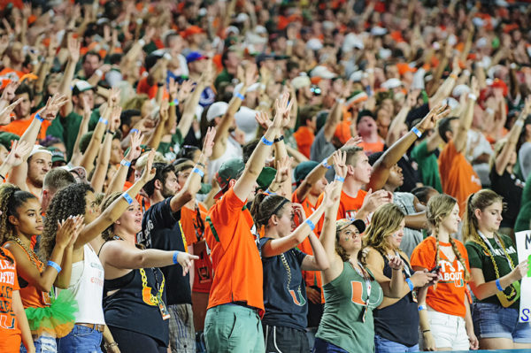 Hurricane fans hold four fingers in the air for the 4th quarter