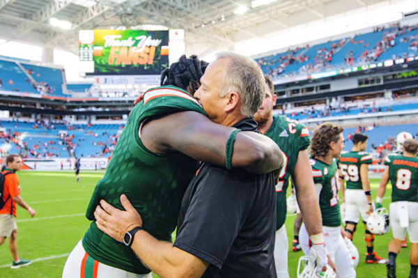 Chad Thomas and Mark Richt embrace after the game