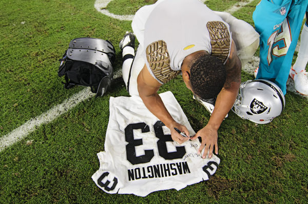 DeAndre Washington (33) writes a message on his jersey