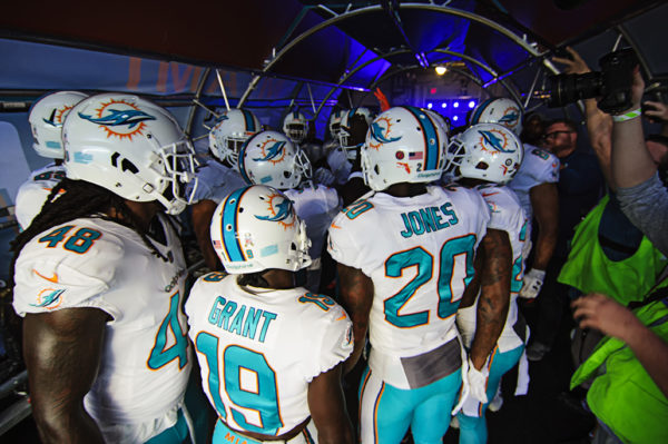 Dolphin players huddle in the tunnel for a pregame speech
