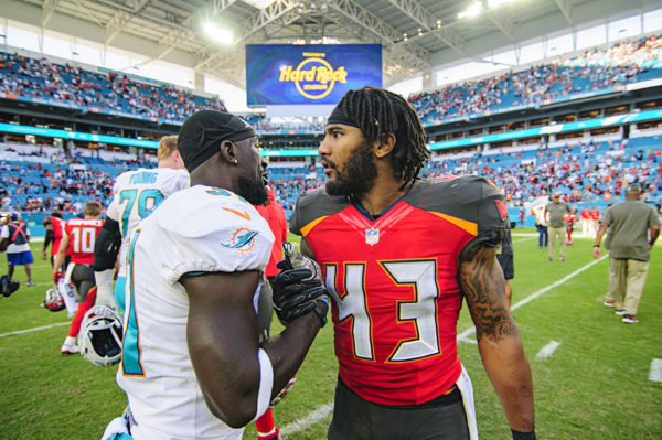 TJ Ward (43) greets Michael Thomas (31) after the game