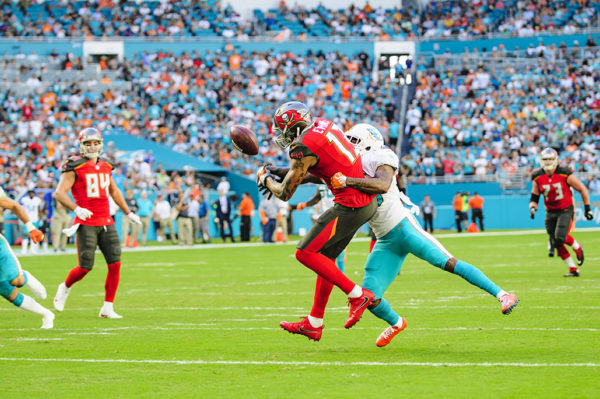Xavien Howard (25) tips the ball away from Mike Evans (13)