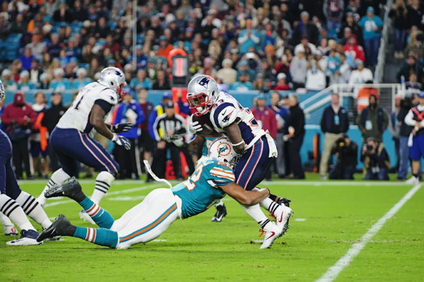 T.J. McDonald (22) hits Dion Lewis (33) behind the line of scrimmage