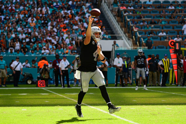 Oakland Raiders quarterback Derek Carr (4) throws on the run